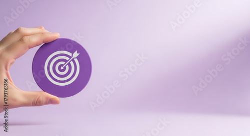 2026 financial goals business goals finance purple target concept hand holding icon focused planning motivation