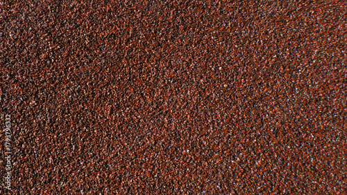 Slika na platnu Close-up of abrasive sandpaper texture in a maroon color
