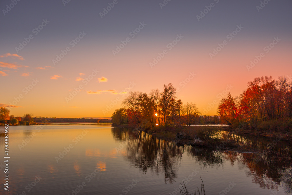 Fototapeta premium Colorful fall leaves with beatiful sunset on the lake