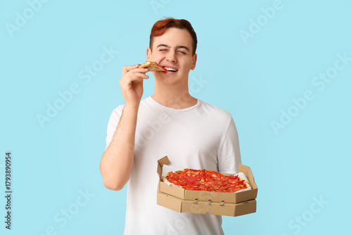 Young man eating piece of t...