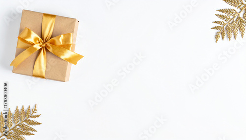 A beautifully wrapped gift box adorned with a golden ribbon, perfect for any special occasion or holiday celebration