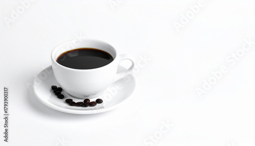 A hot cup of black coffee with roasted beans on a white saucer, perfect for a morning beverage or a coffee break