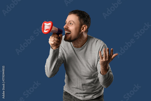 Young man shouting into fun...