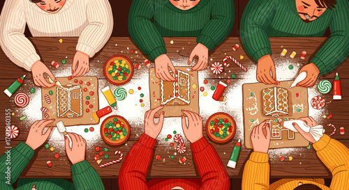 Overhead view of a group of people decorating gingerbread houses with icing and candies at a festive holiday gathering.