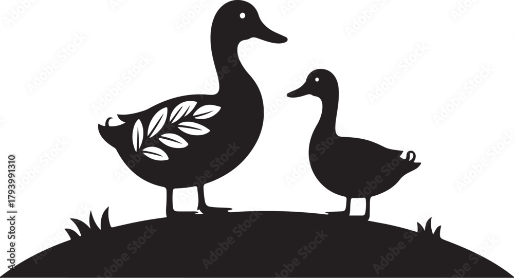 Fototapeta premium Two black silhouette ducks standing on a grassy mound with a white leaf pattern on one duck