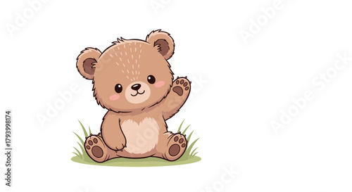 A cute little brown bear sitting in green grass waving its paw hello.