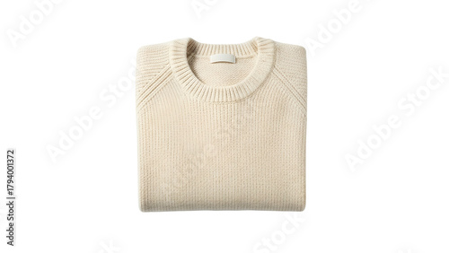 Cream colored knitted pullover garment folded neatly against a dark background