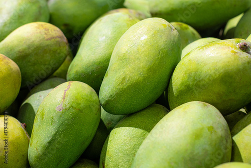 Wallpaper Mural Fresh green mangoes displayed neatly in a supermarket fruit section. Torontodigital.ca
