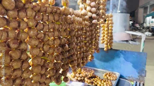 Thai Fermented Sausage (Sai Krok Isan) hanging for sale on street food at thailand, Thai style rice sausage.