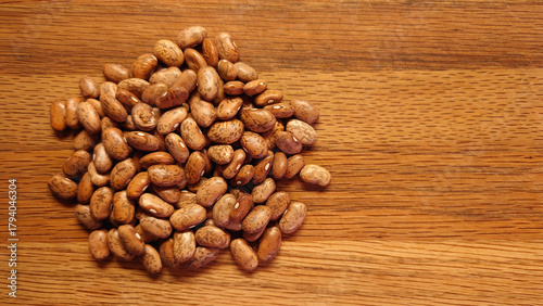 small pile of dried pinto beans on a wooden cutting board