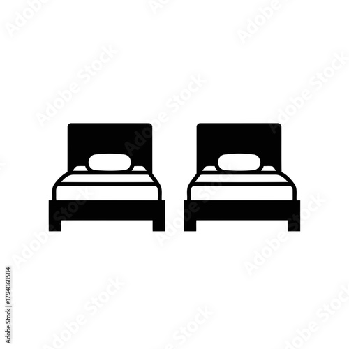 Two identical beds with pillows side by side