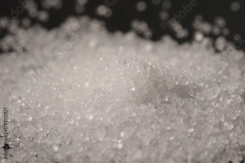 Close-up of the surface of white salt grains, macro salt
