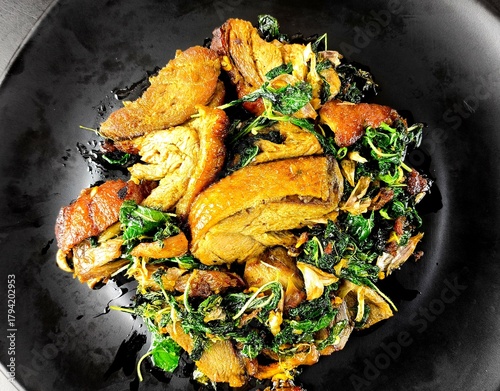 Stir-fried roasted duck with basil in plate, Thai famous food.