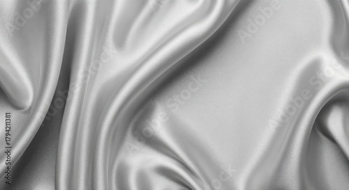 Silky Texture: An abstract display of elegant, flowing fabric in a smooth, subtle silver tone. The interplay of light and shadow creates an enticing visual display.