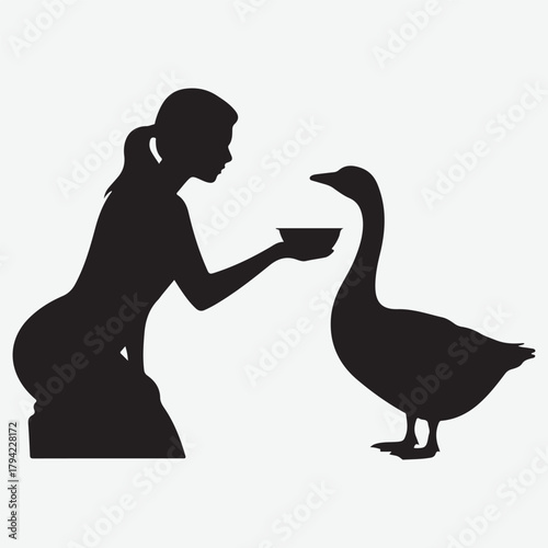 Silhouette of a person feeding a goose from a bowl
