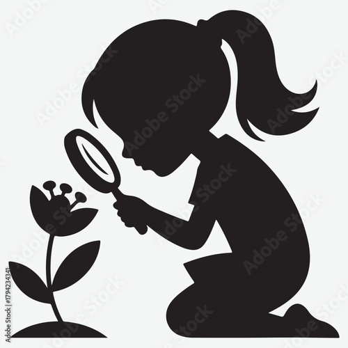 Silhouette of a young girl examining a flower with a magnifying glass