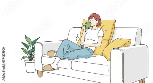 Woman relaxing on a sofa with a cup of tea