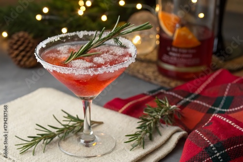 red cocktail decor with christmas theme and rosemary sprig