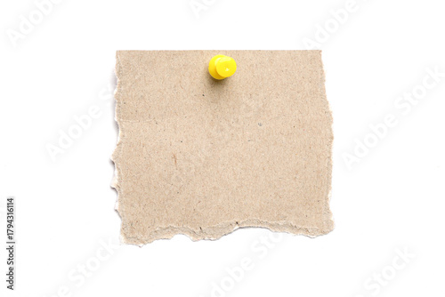 Torn kraft paper sheet with a yellow push pin isolated on a white background, ripped cardboard note for messages
