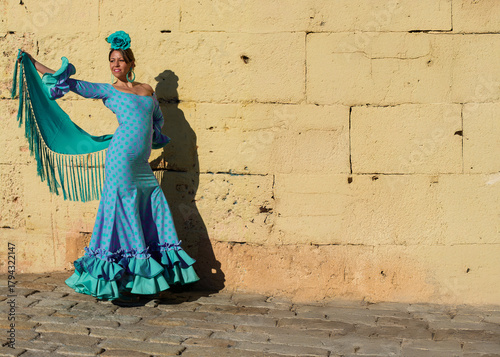 beautiful Spanish girl dances flamenco outdoors