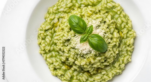 Delicious Pesto Risotto Garnished with Fresh Basil and Parmesan Cheese Served on White Plate Exquisite Italian Cuisine for Food Bloggers and Culinary Enthusiasts