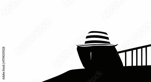 Silhouette of a person wearing a striped hat, looking out from a balcony.