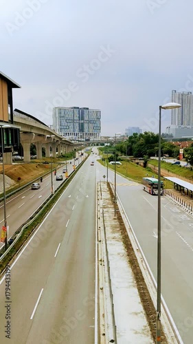 Afternoon City Traffic Beneath the MRT Rails
Cars move along a busy road under elevated MRT rails in soft afternoon light, with reflections on nearby buildings adding a calm urban mood.