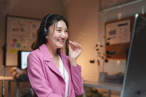 Asian woman working call center smiling talking headset