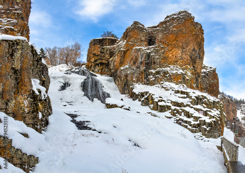 frozen Jermuk waterfall and red rocks of Arpa river canyon (Vayots Dzor, Armenia)