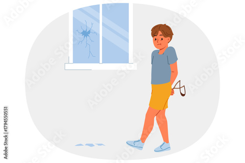 Hooligan boy broke window with slingshot and is afraid of punishment from parents for bad behavior. Hooligan child does pranks due to lack of upbringing or desire to attract attention.