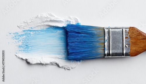 Vibrant photo of paint brush with blue and white paint
