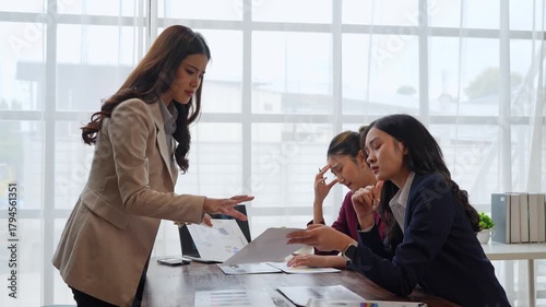 Angry businesswoman scolding employees for poor performance