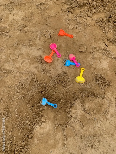 colorful of plastic toy on sand beach background