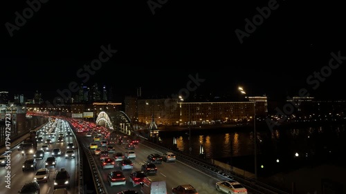 Evening traffic jam in Moscow with cars, lights, and city skyline