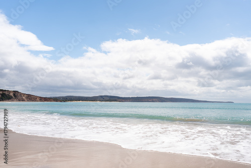 Australian beach with blue sky and clouds