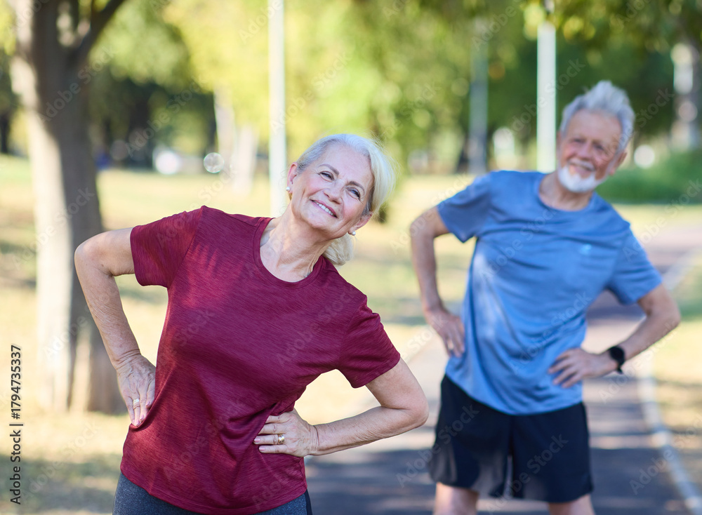 Fototapeta premium Portrait os a happy beautiful elderly senior mature couple exercising and stretching outdoors
