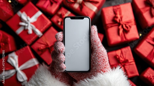 Santa hand holding mobile phone with empty screen in christmas day,holiday shopping online,light background,smartphone,banner sale gifts,Blank white screen,Mockup.