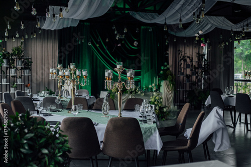 Elegant event venue with luxurious decor and green accents