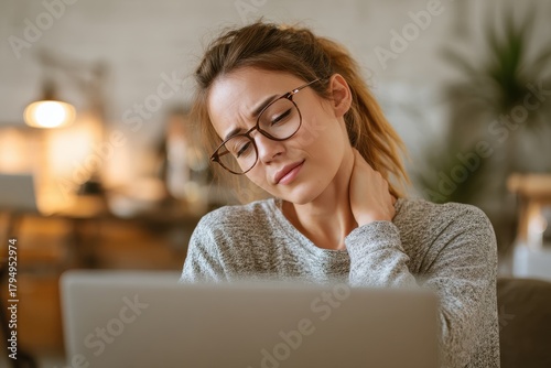 Female using a laptop with neck discomfort