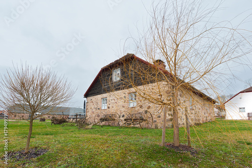 Nurme Manor Building with Antique Agricultural Tools on the Lawn