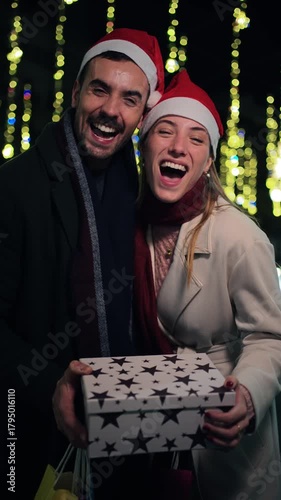 A cheerful couple sharing delightful moments as they exchange gifts, embodying the spirit of the holiday season filled with joy and love, making memories together during this special time.