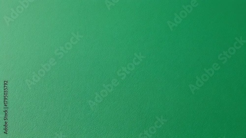 A textured, vibrant green background fills the frame. Light gently falls from one side