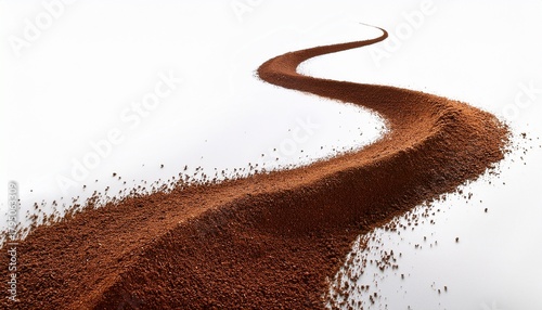 Coffee Grounds In A Flowing Curved Stream Against White