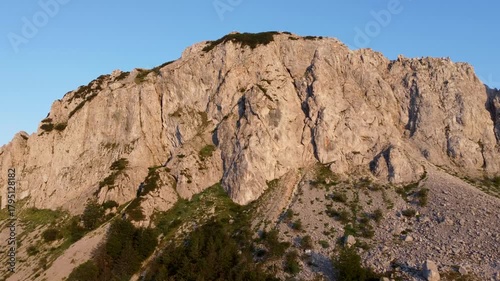 High cliffs on the mountain, aerial drone view. Rocks in nature. Steep rocks on the mountain at sunset. 
