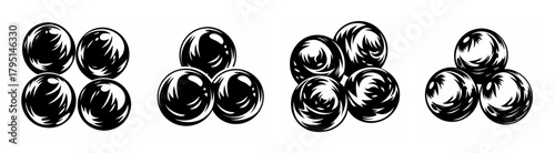 Close up view of shiny marbles stacked in groups showing light reflections and texture on a plain surface