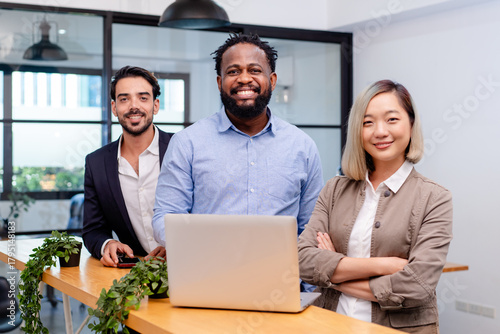 team of multiethnic colleague discuss business topic in creative green office co working space, group of business people coworker casual online meeting on tablet standing desk modern office workplace