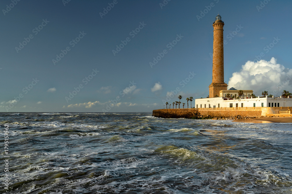 Fototapeta premium Chipiona, Spain. Chipiona Lighthouse on the Ocean Shore. Sea travel and tourism, Atlantic 