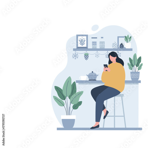 Woman using mobile phone while seated at a winterdecorated kitchen counter leisure time