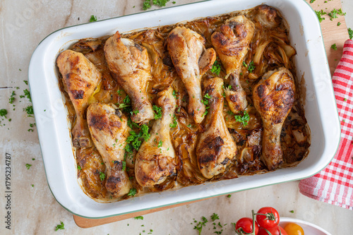 Oven baked chicken drumsticks with braised cabbage in a  casserole dish fresh and homemade cooked