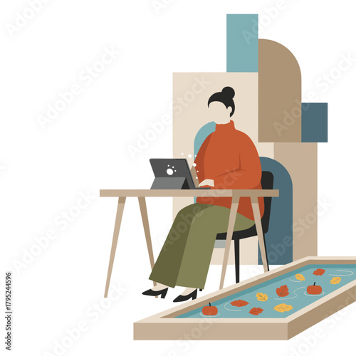 Remote work in autumn Woman using a tablet at a desk with fall leaves and pumpkins nearby